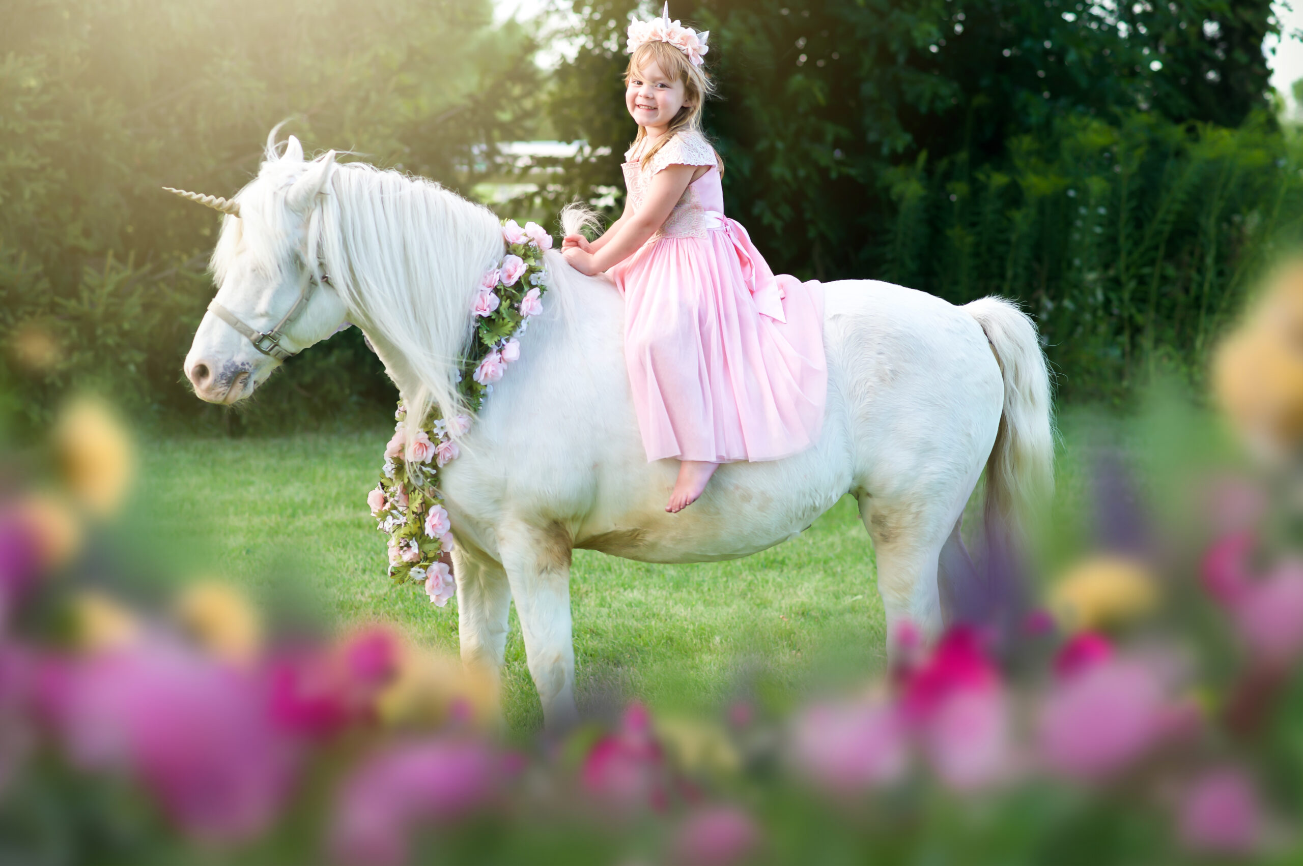 A little girl riding a unicorn
